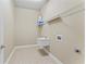 A simple laundry room with a utility sink and wire shelving at 10517 Palm Cove Ave, Tampa, FL 33647