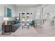 Comfortable living room with french doors, a gray couch, teal accents, and luxury vinyl plank flooring at 10517 Palm Cove Ave, Tampa, FL 33647