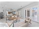 Bright living room featuring modern furnishings, wood-look floors, and sliding glass doors at 10517 Palm Cove Ave, Tampa, FL 33647