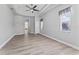 Spacious main bedroom with hardwood floors, tray ceiling, and a view into other areas at 10517 Palm Cove Ave, Tampa, FL 33647