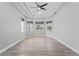 Main bedroom featuring tray ceiling, with large windows and ample natural light at 10517 Palm Cove Ave, Tampa, FL 33647