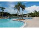 Community pool surrounded by lush tropical landscaping with a charming gazebo and plenty of seating for residents and guests at 10517 Palm Cove Ave, Tampa, FL 33647