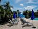 Community pool area with a water slide, poolside seating, and lush tropical landscaping for residents and guests to enjoy at 10517 Palm Cove Ave, Tampa, FL 33647