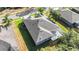 This is an aerial view of a home's rear exterior with a screened-in lanai and a well-maintained lawn at 10517 Palm Cove Ave, Tampa, FL 33647