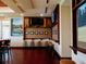 Cozy seating area with high stools, TVs, and golf course photos, creating a relaxing atmosphere at 10517 Palm Cove Ave, Tampa, FL 33647