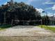 Outdoor sand volleyball court ready for a game, surrounded by lush greenery at 10517 Palm Cove Ave, Tampa, FL 33647