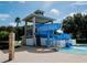Community water slide and tower near poolside seating, all set in a tropical landscaped area for residents enjoyment at 10517 Palm Cove Ave, Tampa, FL 33647