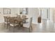 Inviting dining area with elegant wood table set for six, complemented by neutral decor at 10657 Bridgegate Heights Loop, San Antonio, FL 33576