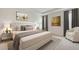 Luxurious main bedroom with a tufted headboard, tray ceiling, and modern decor at 10657 Bridgegate Heights Loop, San Antonio, FL 33576