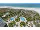 Stunning aerial view showcasing resort-style pools, lush landscaping, and the sparkling ocean at 1170 Gulf Blvd # 2101, Clearwater Beach, FL 33767
