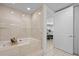 Bathroom features a soaking tub with stone tile surround at 1170 Gulf Blvd # 2101, Clearwater Beach, FL 33767