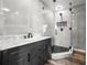 Modern bathroom featuring a glass shower, gray tile, contemporary vanity, and sleek fixtures at 1170 Gulf Blvd # 2101, Clearwater Beach, FL 33767