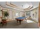 Elegant game room with a classic pool table, stylish seating, and large windows at 1170 Gulf Blvd # 2101, Clearwater Beach, FL 33767