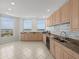 Bright kitchen features granite countertops, stainless appliances, and scenic water views from multiple windows at 1170 Gulf Blvd # 2101, Clearwater Beach, FL 33767