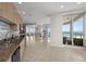 Bright kitchen with granite countertops and stainless appliances opens to dining and living area with ocean views at 1170 Gulf Blvd # 2101, Clearwater Beach, FL 33767