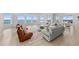 Spacious living room featuring tile floors and expansive windows that offer breathtaking ocean views at 1170 Gulf Blvd # 2101, Clearwater Beach, FL 33767