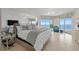 Serene main bedroom featuring large windows with ocean views, complemented by tile flooring and elegant decor at 1170 Gulf Blvd # 2101, Clearwater Beach, FL 33767