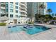 Beautiful community pool with clear blue water and seating surrounded by lush landscaping and condominium buildings at 1170 Gulf Blvd # 2101, Clearwater Beach, FL 33767