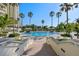 Inviting community pool with lounge chairs and tropical landscaping, offering a relaxing oasis at 1170 Gulf Blvd # 2101, Clearwater Beach, FL 33767