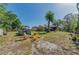 Large backyard with a pool, seating area, and ample space for entertaining, perfect for outdoor gatherings at 12923 Colony Rd, Hudson, FL 34669