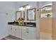 Bathroom with granite countertops, natural lighting, and a glass block window at 12923 Colony Rd, Hudson, FL 34669