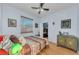Bedroom with a ceiling fan, an external window and access to a walk in closet at 12923 Colony Rd, Hudson, FL 34669