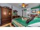 This primary bedroom includes a dresser, ceiling fan and private entry into a full bathroom at 12923 Colony Rd, Hudson, FL 34669