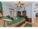 A primary bedroom including a private outdoor entry and hardwood floors at 12923 Colony Rd, Hudson, FL 34669