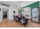 Bright dining room boasts wood floors, a decorative chandelier, and unique cow print dining chair covers at 12923 Colony Rd, Hudson, FL 34669