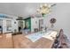 The dining room features a chandelier, long wood table with cow print chairs, and bright natural light at 12923 Colony Rd, Hudson, FL 34669