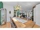 This dining room has rustic wood table, cow print chairs, and decor, with an adjacent room visible at 12923 Colony Rd, Hudson, FL 34669