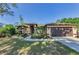 Charming single-story home with a well-manicured lawn and inviting front entrance at 12923 Colony Rd, Hudson, FL 34669