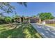 Lovely home with a paved driveway, lush lawn and landscaping, and neutral exterior paint at 12923 Colony Rd, Hudson, FL 34669