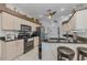 Well-lit kitchen features black countertops, stainless appliances, and off-white cabinetry at 12923 Colony Rd, Hudson, FL 34669