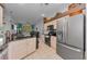 Bright kitchen flows into the living area, featuring granite counters and stainless steel appliances at 12923 Colony Rd, Hudson, FL 34669