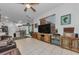 The spacious living room leads to the kitchen and dining area with tiled floors at 12923 Colony Rd, Hudson, FL 34669