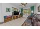 Cozy living room with a tv, bamboo shades, and wood-look console table at 12923 Colony Rd, Hudson, FL 34669