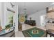 Comfortable living room featuring an exterior door, leather seating, and tiled flooring at 12923 Colony Rd, Hudson, FL 34669