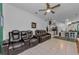 Wide-angle view of the open living space from the kitchen, with leather seating at 12923 Colony Rd, Hudson, FL 34669