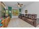 Living room showcasing a media center, multiple windows, and comfortable leather seating at 12923 Colony Rd, Hudson, FL 34669