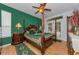 Main bedroom featuring hardwood floors, a four-poster bed, and access to the outside at 12923 Colony Rd, Hudson, FL 34669