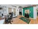 Home office with a fireplace, wood floors, and view into the living area at 12923 Colony Rd, Hudson, FL 34669