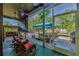 Screened patio featuring rocking chairs, a swing, and an outdoor view of the backyard and patio at 12923 Colony Rd, Hudson, FL 34669