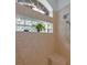 Shower with natural light, glass block windows, tiled flooring, and full shower system at 12923 Colony Rd, Hudson, FL 34669