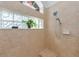 Shower with natural light, glass block windows, and tiled corner seat at 12923 Colony Rd, Hudson, FL 34669