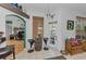 Bright sitting area with decorative barrel table, tiled floor, and doorway to office space at 12923 Colony Rd, Hudson, FL 34669