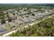 Aerial view showing the community, highlighting backyard pools and neighborhood streets surrounded by lush greenery at 13637 Blythewood Dr, Spring Hill, FL 34609