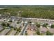 An aerial view showcases the community layout, emphasizing proximity to wooded areas and neighborhood design at 13637 Blythewood Dr, Spring Hill, FL 34609