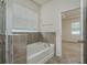 Bathroom showcasing a soaking tub with tiled surround and a view to the main bedroom at 13637 Blythewood Dr, Spring Hill, FL 34609