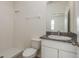 Bathroom with a granite countertop vanity, toilet, and a shower with a glass door at 13637 Blythewood Dr, Spring Hill, FL 34609